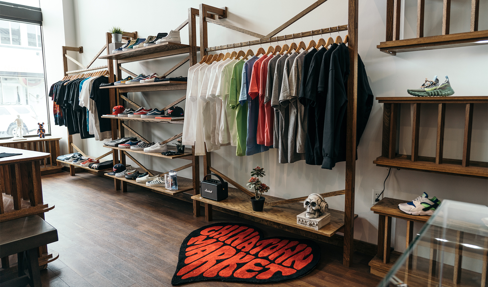 Streetwear boutique with neatly displayed men's t-shirts and sneakers on wooden racks