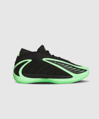 Black and neon green low-top sneaker with sculpted details on a plain background