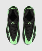 Top view of black and neon green men's streetwear sneakers on a light gray background