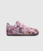 Pink floral low-top sneaker with cherry blossom details on a white background