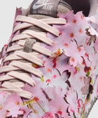 Close-up of Nike Air Force 1 sneaker in pink with cherry blossom floral cutout design