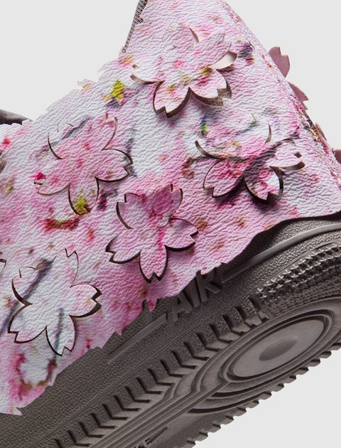 Closeup of sneaker with pink cherry blossom petal overlays and textured sole