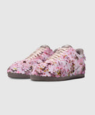 Low-top sneakers with pink cherry blossom floral 3D appliqué design on a gray sole