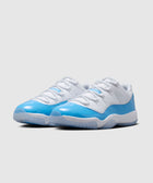 White and blue low-top sneakers with patent leather toe on a neutral background