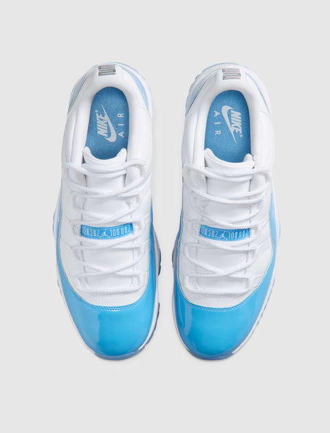Pair of white and blue low-top sneakers with patent leather and Nike Air logo on insoles