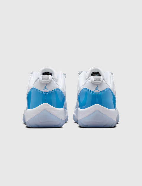 Back view of white and blue low-top sneakers with glossy blue heel detail on a plain background