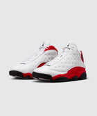 White and red retro basketball sneakers with textured leather and black outsoles on gray background.