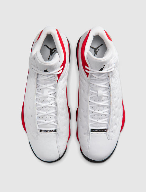 Top view of white and red leather sneakers with black accents and 'JORDAN' label on tongues