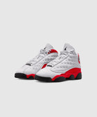White and red Air Jordan 13 sneakers with black soles on a plain background