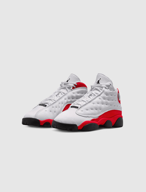 White and red Air Jordan 13 sneakers with black soles on a plain background
