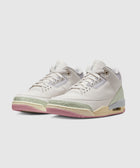 White leather sneakers with pastel green and pink accents, visible air sole, stylish streetwear shoes