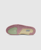Colorful sneaker outsole with pink, cream, and green accents, showing Nike logo