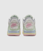 Back view of pastel Nike Air sneakers with pink, green, and yellow accents on a white background.