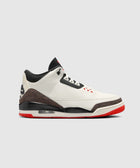 White, black, and red men's sneaker with elephant print and visible air sole on gray background