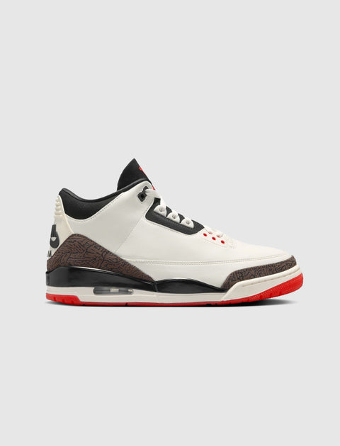 White, black, and red men's sneaker with elephant print and visible air sole on gray background