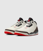 White and black sneakers with red soles, elephant print accents, and visible air cushioning