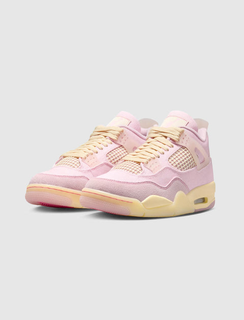 Pastel pink and cream suede sneakers with mesh panels and yellowed sole on light background