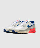 White and grey athletic sneakers with blue swoosh and vibrant red accents on the sole