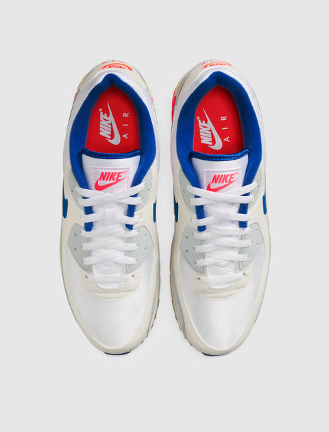 Pair of white Nike Air Max sneakers with blue and red accents, top view