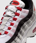 White, red, and grey mesh sneaker with visible air cushioning and bold stitching details
