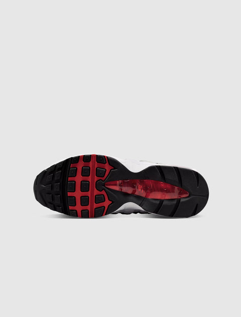 Black and red rubber sneaker sole with textured tread pattern on white background