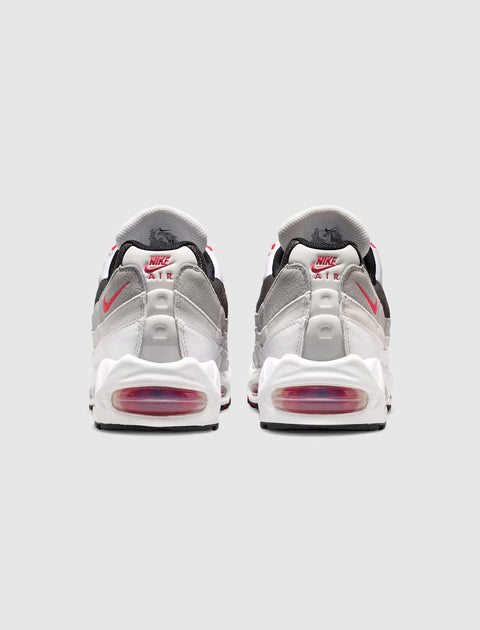 Back view of white, grey, and red Nike Air Max 95 sneakers with visible Air cushioning