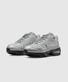 Pair of silver athletic sneakers with mesh and leather upper on a white background