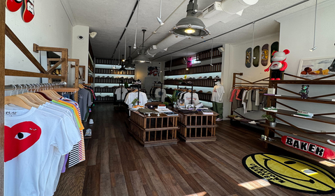 Urban streetwear boutique with graphic tees, sneakers, skateboards, and modern decor