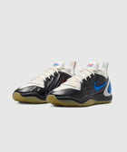 Black and white low-top sneakers with blue side swoosh, gum sole, and unique heel tabs.