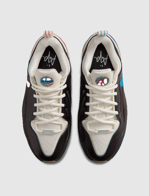 Top view of black and white men's sneakers with graphic tongue logos and contrast lace details