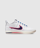 White low-top sneaker with blue and red swoosh, cream sole, on light gray background