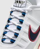 White sneaker with red and navy blue swoosh, blue lace accents, and 'BOOK' basketball logo on tongue