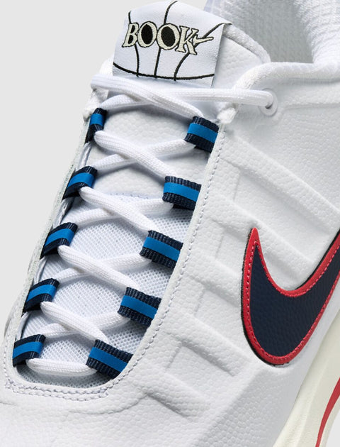 White sneaker with red and navy blue swoosh, blue lace accents, and 'BOOK' basketball logo on tongue