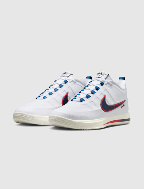 White basketball sneakers with blue and red accents, side view, rubber sole, lace-up style