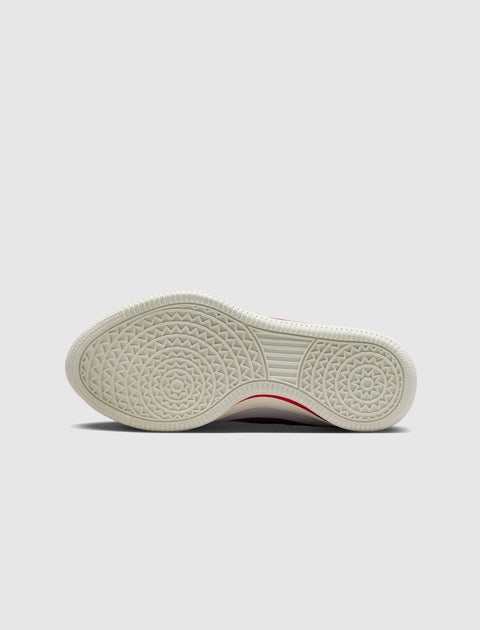 White sneaker sole with geometric circular traction pattern, viewed from the bottom