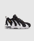 Black and white men's sneaker with gold accents, chunky sole, side view on plain background