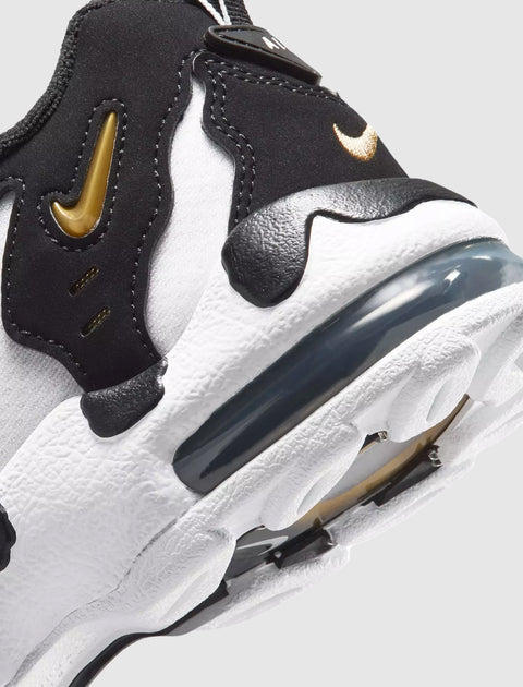 Close-up of black and white sneaker with gold accents and visible air-cushioned sole