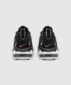 Black and gold Air sneakers rear view with visible air cushion sole on white background
