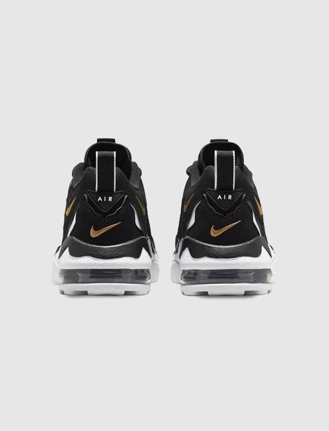 Black and gold Air sneakers rear view with visible air cushion sole on white background
