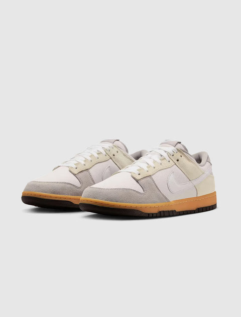 Pair of low-top sneakers with white, beige, and grey panels and gum rubber soles
