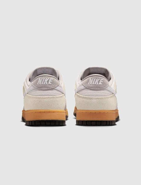 Back view of grey and white low-top sneakers with gum soles on white background
