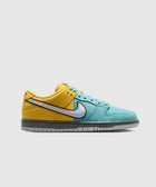 Yellow and teal low-top sneaker with iridescent Swoosh and grey sole on white background