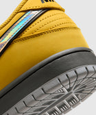 Closeup of yellow sneaker heel with iridescent detail and grey outsole