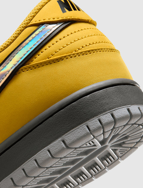 Closeup of yellow sneaker heel with iridescent detail and grey outsole