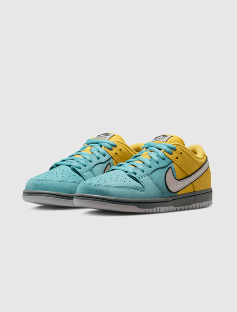 Pair of low-top sneakers with teal blue front, yellow back, and light grey swoosh on white background