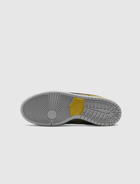 Grey and yellow sneaker outsole with circular tread pattern on white background