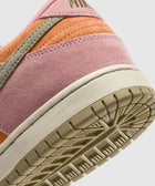 Close-up of a pink, orange, and beige suede sneaker heel with textured outsole