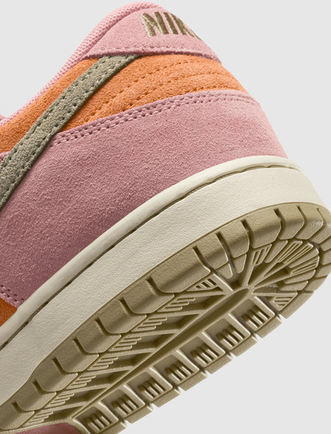 Close-up of a pink, orange, and beige suede sneaker heel with textured outsole