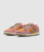 Pink and orange suede low-top sneakers with olive green laces and Swoosh logo on white background