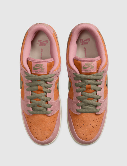 Top view of two low-top sneakers with orange suede toes, pink trim, and olive green laces.